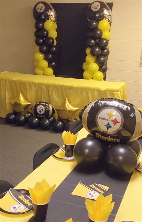 balloons and decorations are set up for a pittsburgh football party