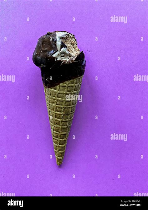 bitten chocolate ice cream cone, empty seat Stock Photo - Alamy