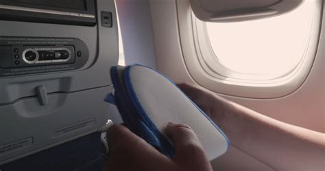 Woman unfolding slippers in the airplane 28898719 Stock Video at Vecteezy