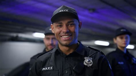 Premium Photo | African american policeman smiling at camera with ...