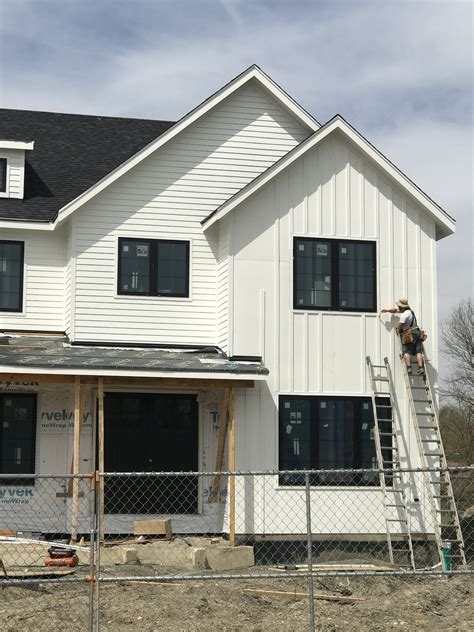 Board batten siding #boardandbattensiding Black and white home. Lap siding with board and batten ...