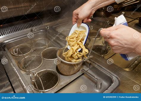 Chef is cooking pasta stock image. Image of pasta, equipment - 69590399