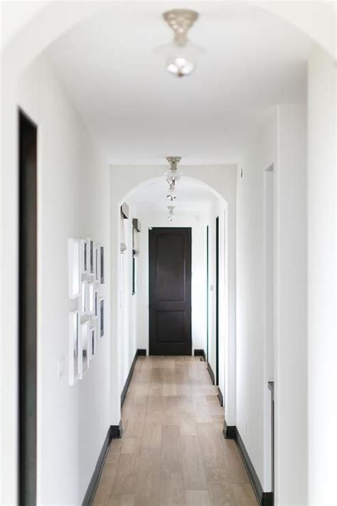 Long white and black hallway | White hallway, Black baseboards, Black ...