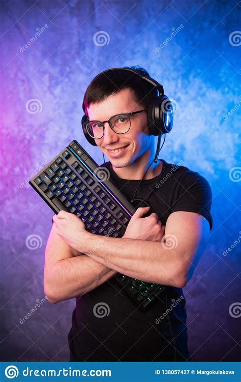 Professional Boy Gamer Holding Gaming Keyboard Over Colorful Pink and ...