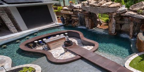 This Guitar Shaped Pool Features a Rock Waterfall and Swim-up Bar - Mad ...