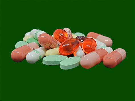 Pills On Green Background Free Stock Photo - Public Domain Pictures