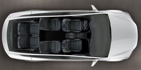 an overhead view of a silver car with seats in the center and four ...