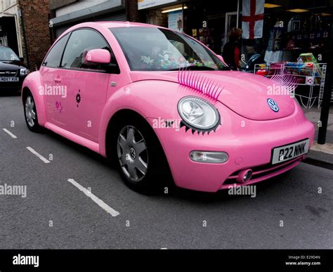 Modern Volkswagen Beetle car in exaggerated "girly" colours bright pink ...