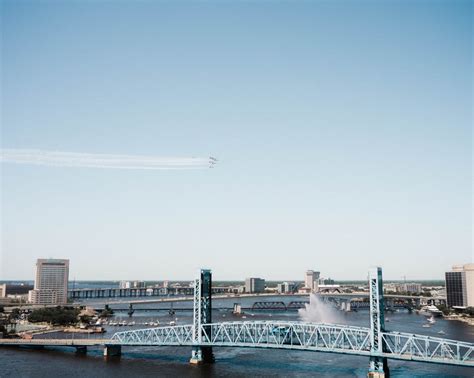 White Airplane Flying over City Skyline · Free Stock Photo