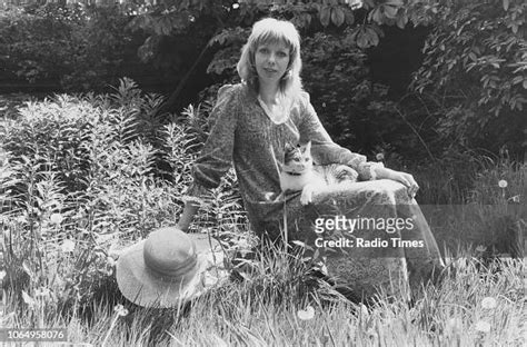 Portrait of actress Tamara Ustinov sitting outdoors with a cat on her ...