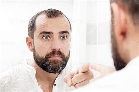 Man looking at himself in the mirror and pointing 1258259 Stock Photo at Vecteezy