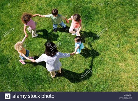 Teacher playing game of ring a ring o roses with children 3 5 on Stock Photo, Royalty Free Image ...