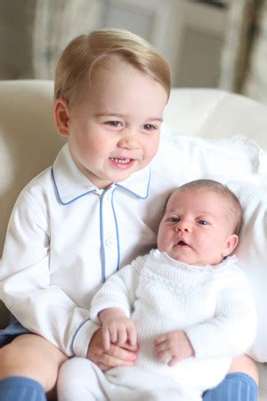 Prince William, age 2, holds baby brother, Prince Harry and Prince George, age 22 months, holds ...