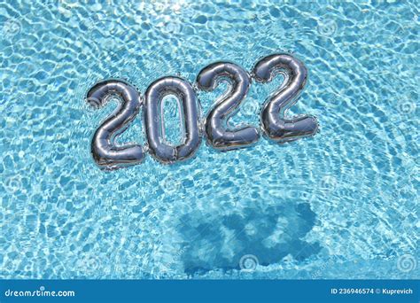 Helium Balloons with Numbers 2022 Lying on Water in Swimming Pool Top View Closeup Background ...