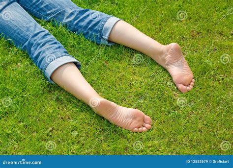 Legs Of Relaxing Woman In Grass Royalty Free Stock Images - Image: 13552679