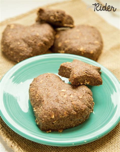 three heart shaped cookies sitting on top of a blue plate next to some ...