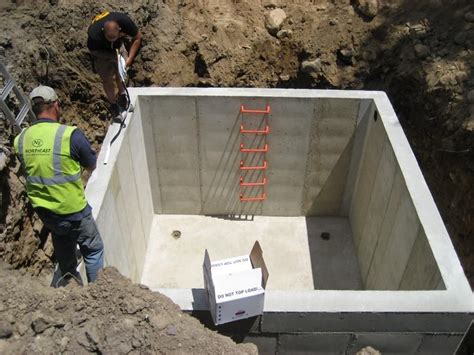 Small underground concrete cisterns. Built on top of a wooden platform ...