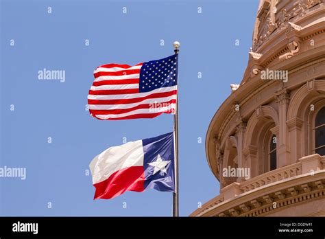 US and Texas flags flying over Texas State Capitol building Austin USA Stock Photo - Alamy