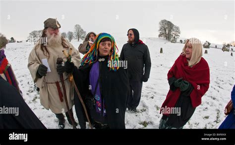 Druids celebrating the Winter Solstice in the snow at Avebury stone ...