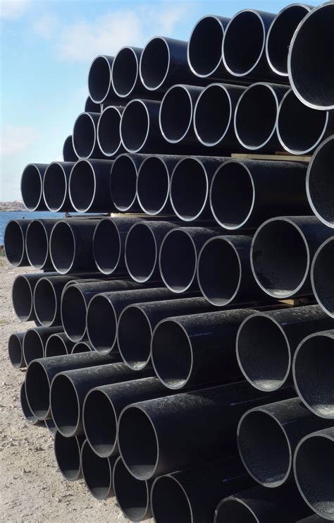 File:Stack of large dusty black plastic pipes.jpg - Wikimedia Commons