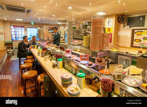 Japanese People Eating Sushi From Sushi Conveyor Belt At Japanese ...