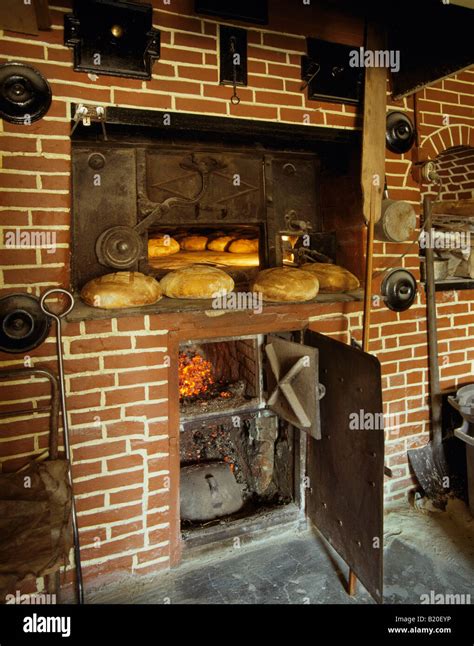 Baking bread in a wood fired oven La Roquette near Perigueux Dordogne Stock Photo: 18451434 - Alamy