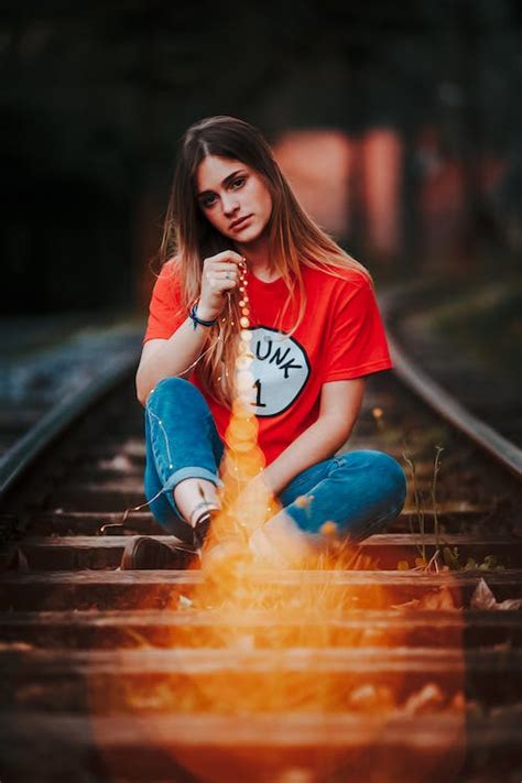 Woman Sitting on Train Tracks · Free Stock Photo