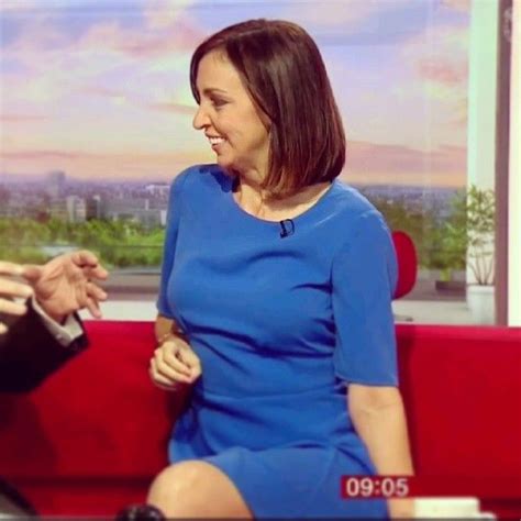 a man and woman sitting on a red couch talking to each other