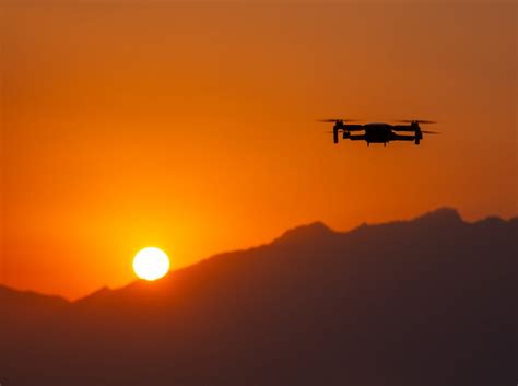 Silhouette of Flying Drone at Sunset · Free Stock Photo