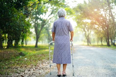 Premium Photo | Asian senior or elderly old lady woman patient walk with walker in park.