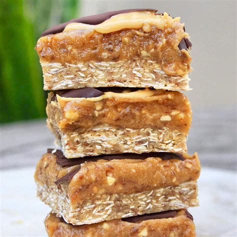 Chewy coconut caramel slice 💥 with a slather of smooth @byronbaypeanutbutter under a dark choc ...