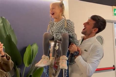 Novak Djokovic lifts daughter Tara in the ATP Finals trophy