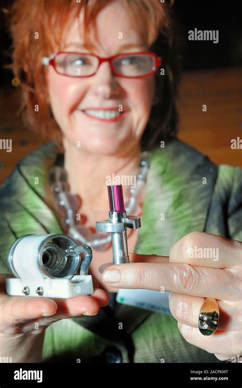 First laser. Kathleen Maiman, widow of Theodore Maiman (1927-2007), holding the solid-state ...