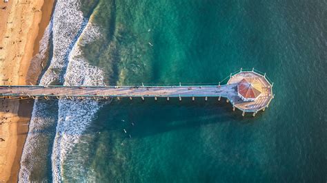 Aerial view of Manhattan Beach Pier over the Pacific Ocean at sunset ...