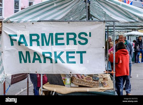 A Farmers' Market banner tied to a open air market stall in Cirecnester, Gloucestershire, UK ...