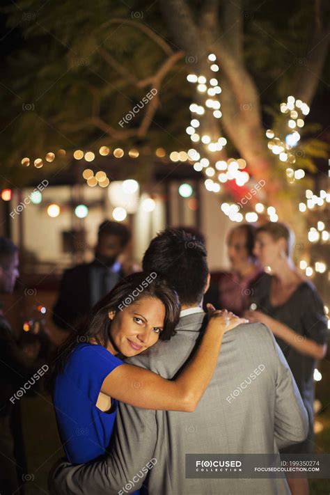 Couple hugging at party — affection, hospitality - Stock Photo | #199350274