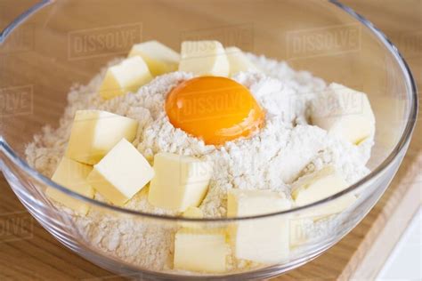 Flour egg and butter in a bowl - Stock Photo - Dissolve