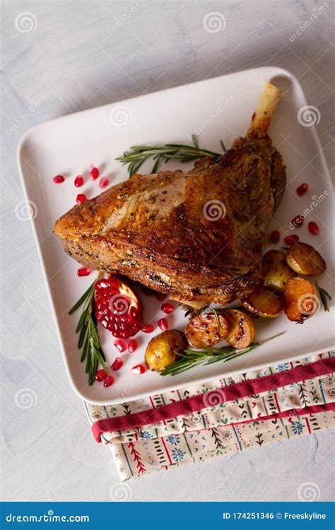 Roast Leg of Lamb with Potatoes, Pomegranate and Rosemary. Stock Photo - Image of dinner, cooked ...