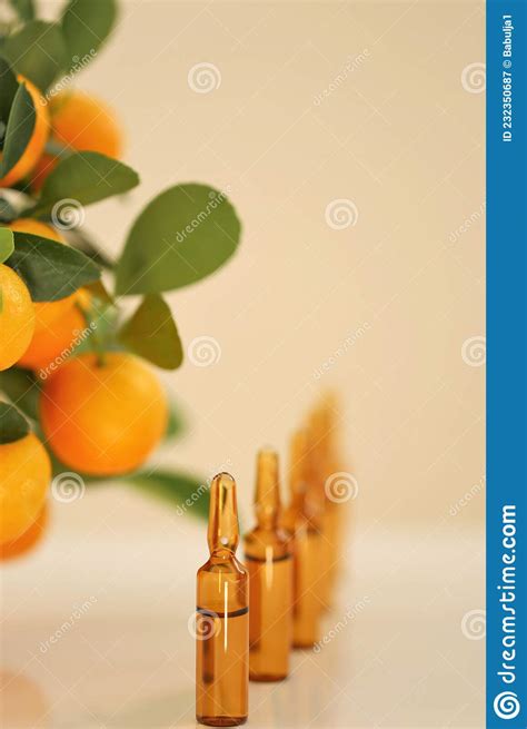 Vitamin C. Serum with Vitamin C.Glass Ampoules and Tangerine Fruit .ampoules and Serum with ...