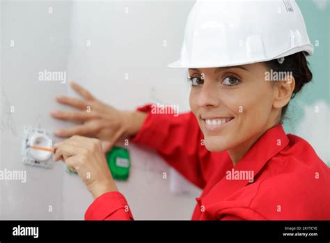 female electrician testing a wall socket Stock Photo - Alamy