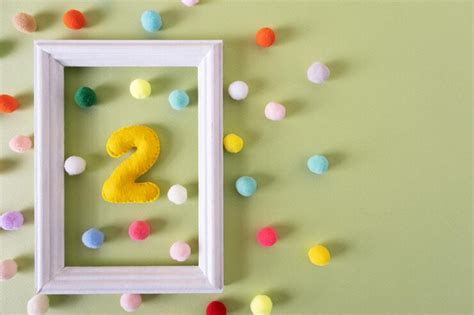 Premium Photo | The number Two for a birthday in a white frame with colored balls Festive ...