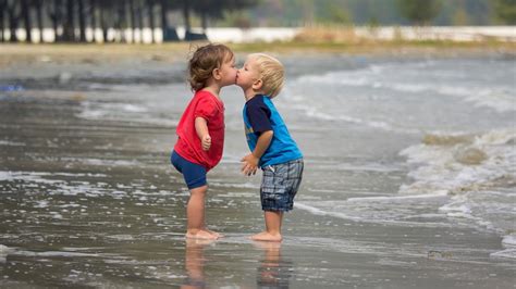 Cute Kids Are Standing On Beach Water Kissing Each Other Wearing Red ...