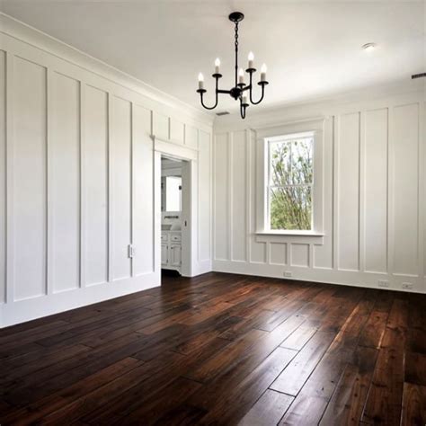 Vertical Board and Batten Walls Frame a Coastal White Bedroom Sitting on a Field of Walnut ...