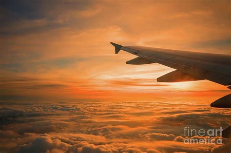 Wing Of An Aeroplane At Sunset by Taisen Lin