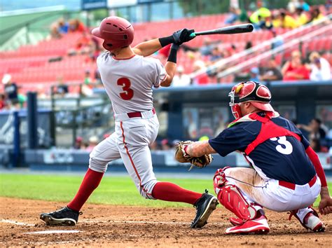 baseball player hitting and sliding - Pro Baseball Insider