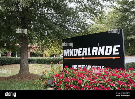 A logo sign outside of a facility occupied by Vanderlande Industries in ...