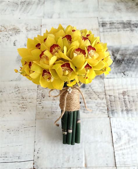 Yellow Orchid arrangement with cymbidium, oncidium and horsetail ...