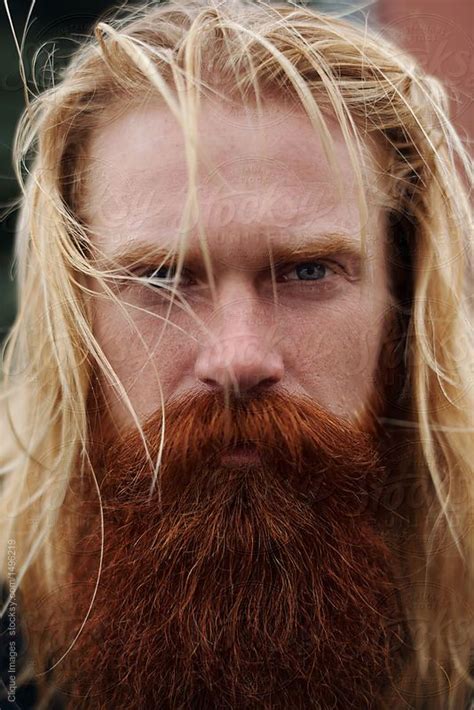 Portrait of handsome nordic man Portrait of serious middle-aged man with long blond hair, red ...