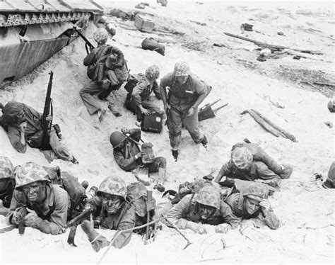 Soldiers In Taking Cover In Shell Hole by Bettmann