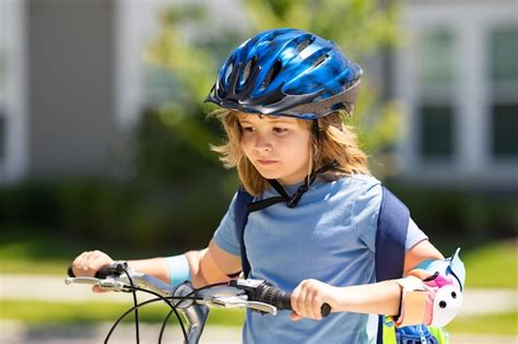 Premium Photo | Kid riding bike in a helmet child riding bike in ...